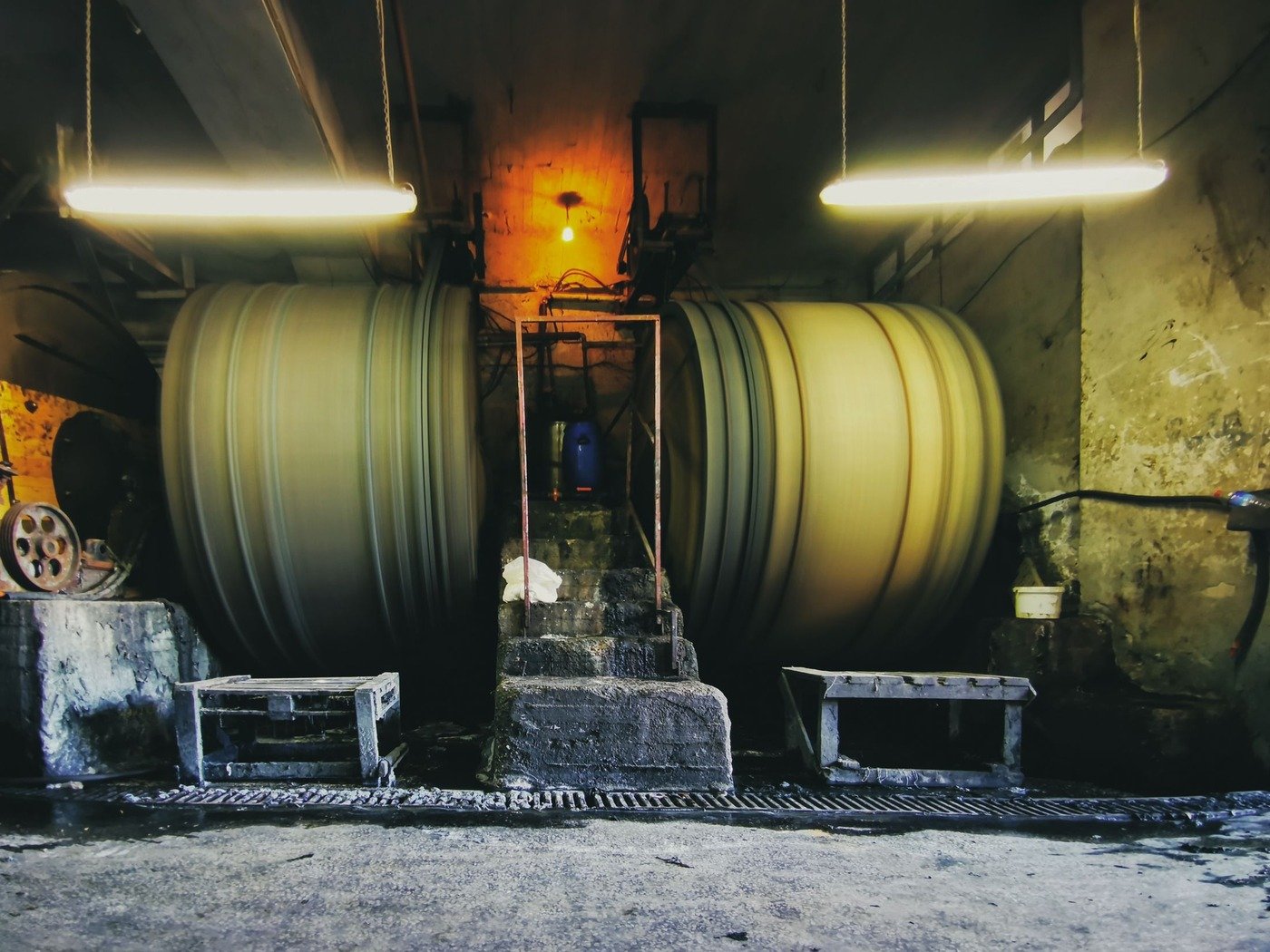 Large rotating drums in an industrial processing hall