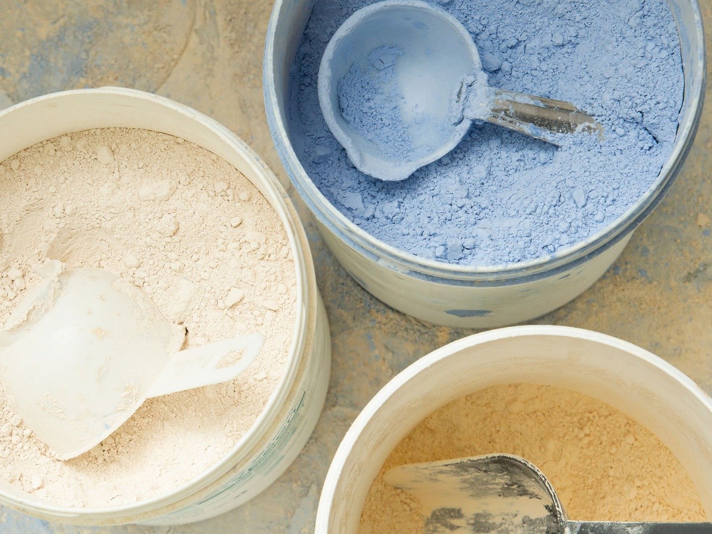 Scoops resting in tubs of fine powder, ready for a sample to be drawn