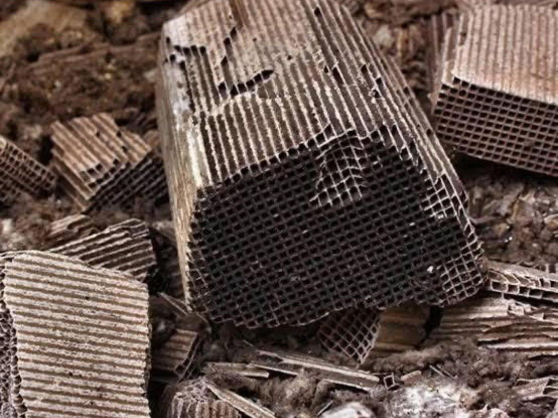 Broken pieces of ceramic catalyst substrate, the honeycomb channels visible in cross-section